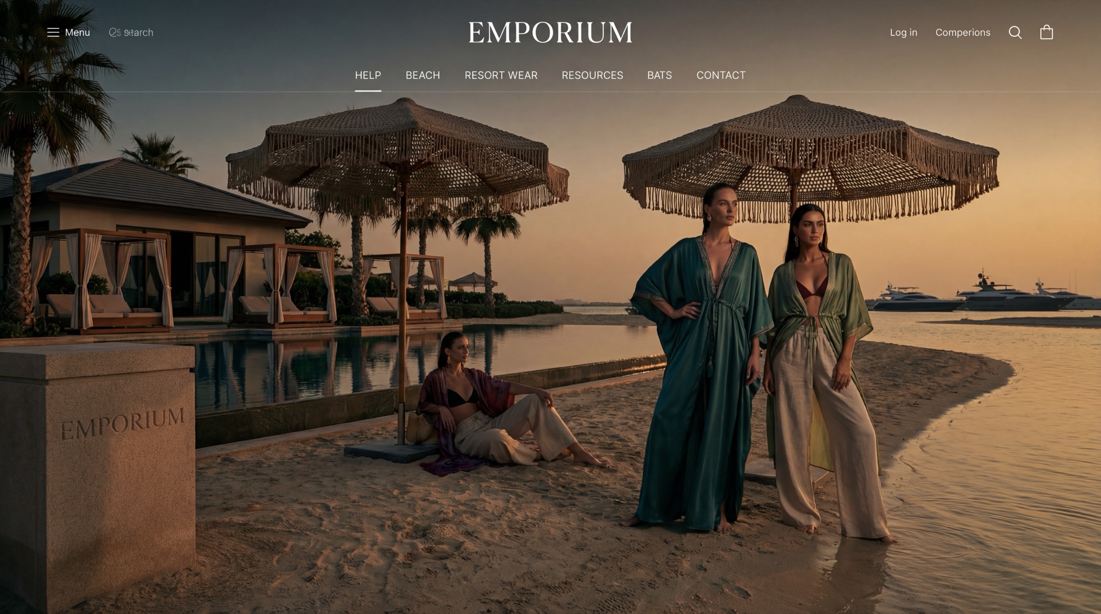 Two models in teal and cream kaftans on a Maldives beach at twilight